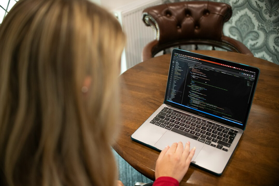 person learning to code on laptop